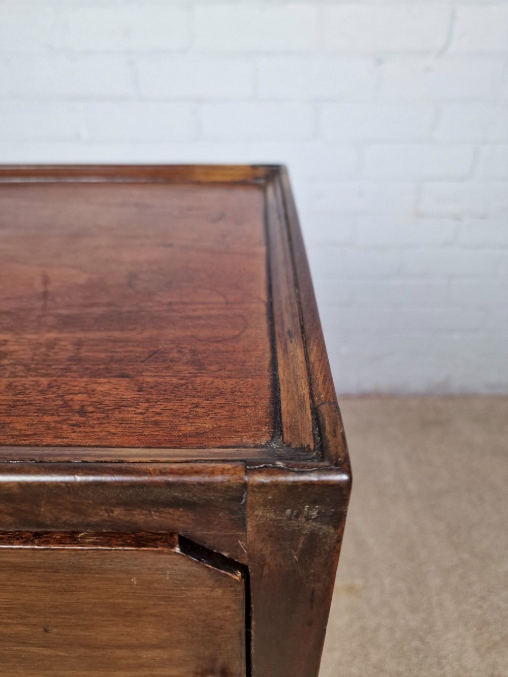 A tall Georgian dark mahogany bedside cabinet with a single door cupboard, straight legs, and an arched lower X-stretcher shelf. View IX