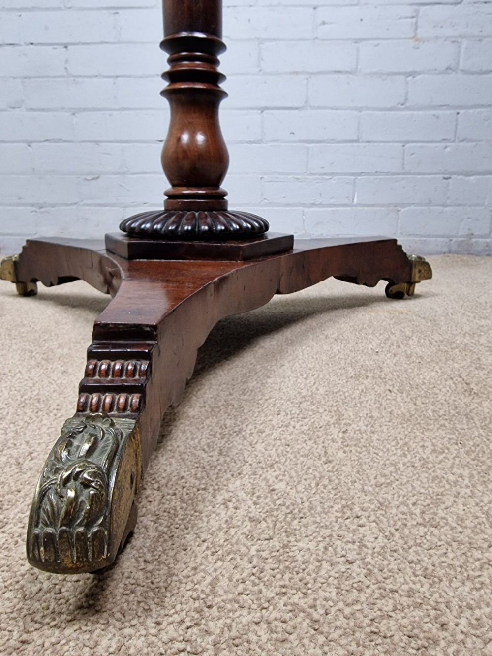 A tall late Georgian mahogany coat stand featuring turned and reeded central pillars, curved hanging hooks, and a splayed tripod base with brass castors. View III