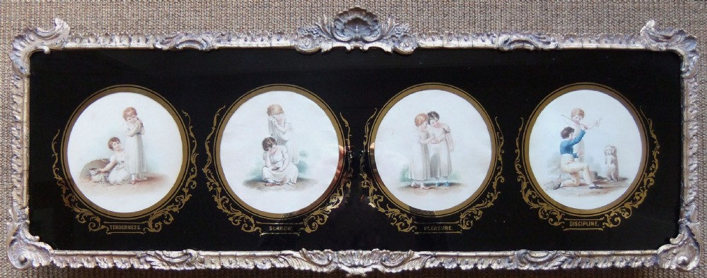 A horizontal carved giltwood frame enclosing four circular Regency engravings set within a black glass mount decorated with gold foliage.