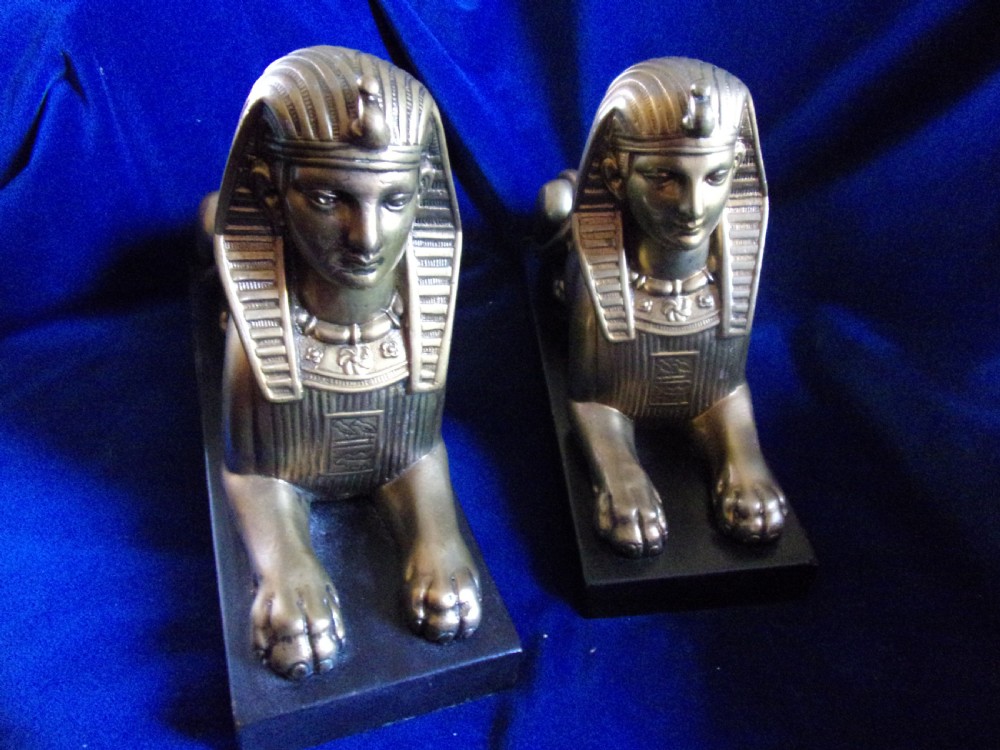 A pair of late 19th-century gilt bronze sphinxes wearing nemes headcloths, mounted on rectangular black marble bases. View II