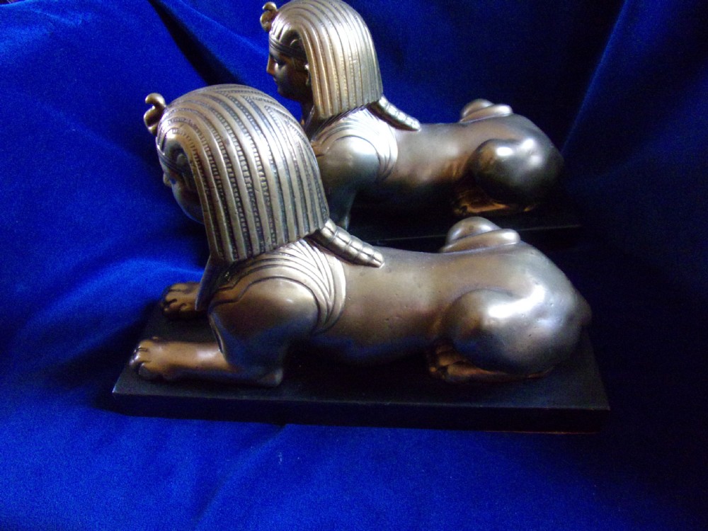 A pair of late 19th-century gilt bronze sphinxes wearing nemes headcloths, mounted on rectangular black marble bases. View IV