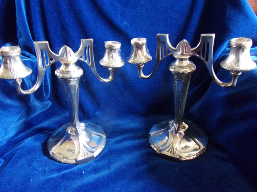A pair of antique silver-plated two-light candelabra featuring Jugendstil geometric designs and circular bases. View III