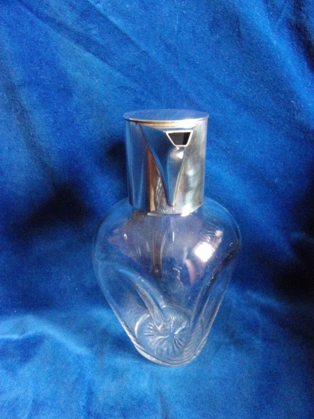 An Arts and Crafts clear glass claret jug featuring a silver-plated hinged collar, angular handle, and flat lid. View III