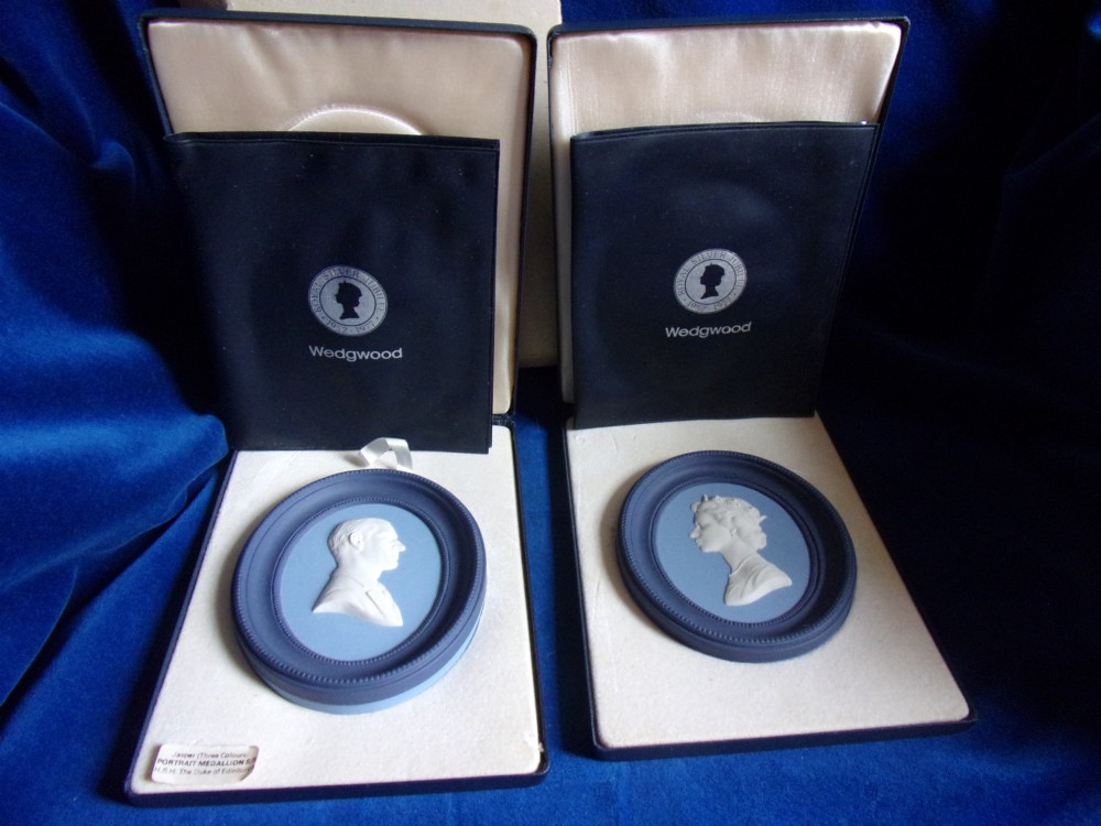 A pair of framed oval Wedgwood blue and white jasperware medallions depicting profile portraits of Queen Elizabeth II and Prince Philip in dark presentation boxes. View II