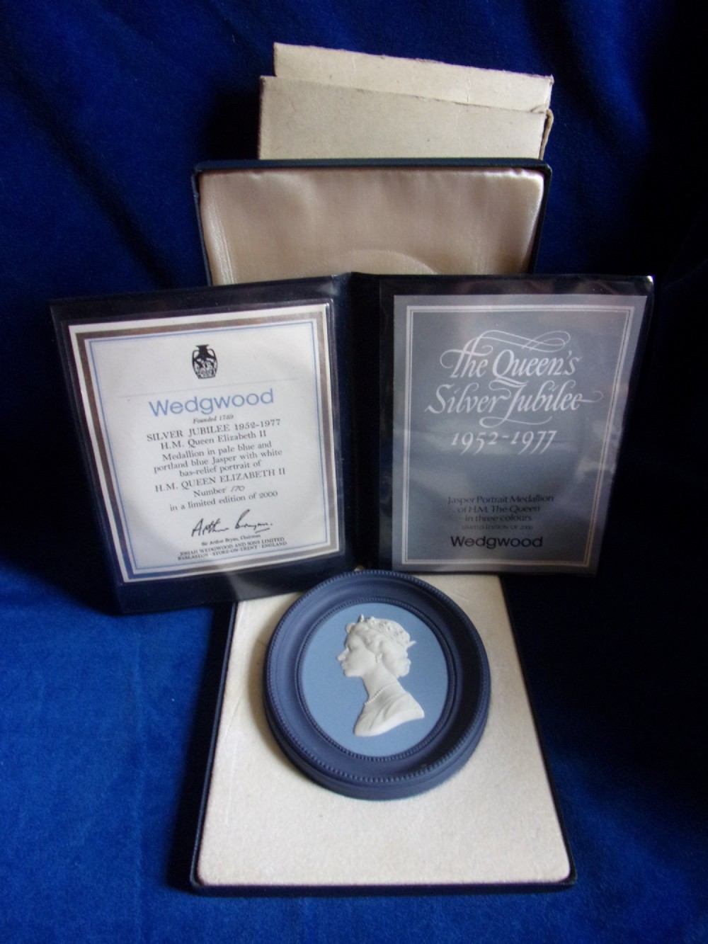 A pair of framed oval Wedgwood blue and white jasperware medallions depicting profile portraits of Queen Elizabeth II and Prince Philip in dark presentation boxes. View III