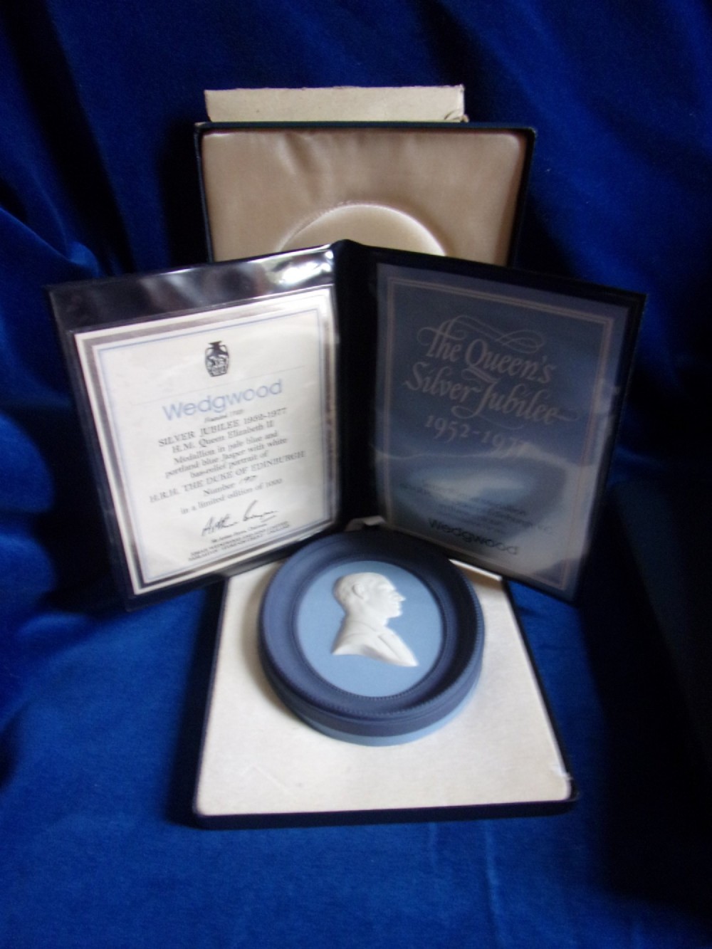 A pair of framed oval Wedgwood blue and white jasperware medallions depicting profile portraits of Queen Elizabeth II and Prince Philip in dark presentation boxes. View IV
