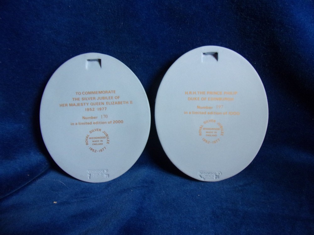 A pair of framed oval Wedgwood blue and white jasperware medallions depicting profile portraits of Queen Elizabeth II and Prince Philip in dark presentation boxes. View VI