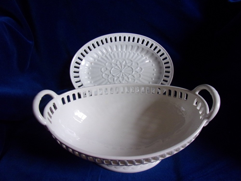 A cream-coloured glazed earthenware basket featuring pierced lattice rims, twin side handles, and a matching reticulated stand. View II