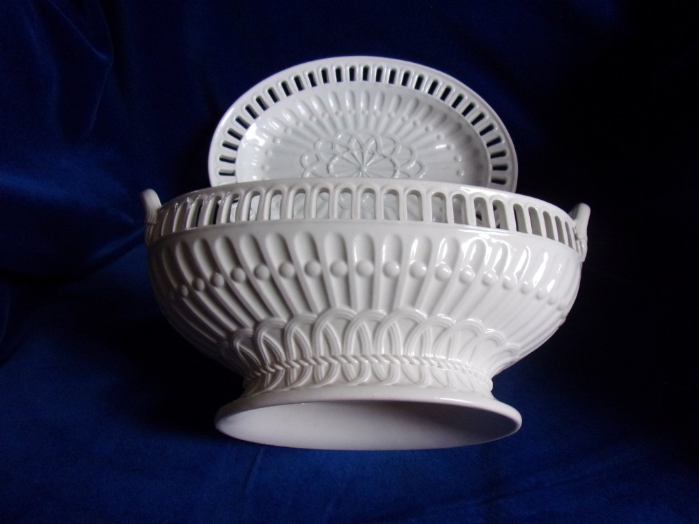 A cream-coloured glazed earthenware basket featuring pierced lattice rims, twin side handles, and a matching reticulated stand. View III