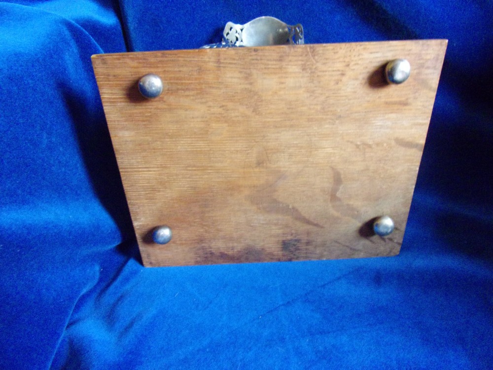 An Edwardian fretted silver standish featuring two glass inkwells mounted on a rectangular carved oak base. View VIII