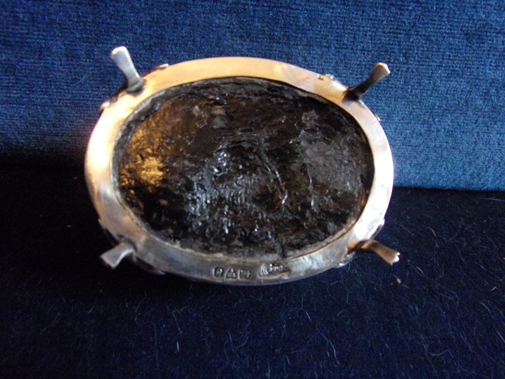 An oval sterling silver trinket box with a smooth polished lid resting on four slender cabriole feet. View VII