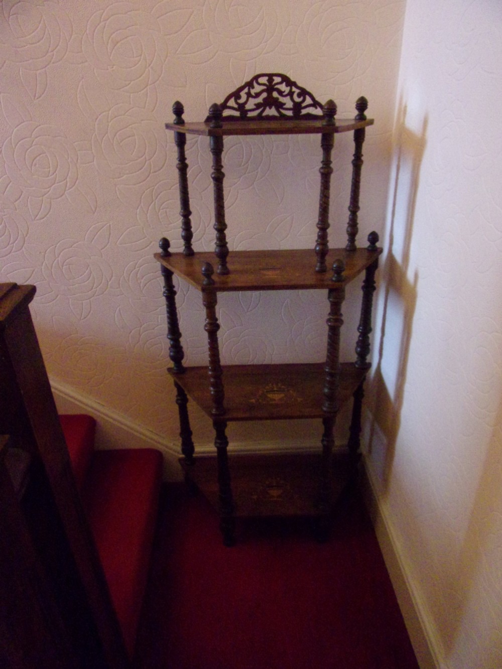 A Victorian walnut tiered whatnot stand featuring four tiers with satinwood urn inlay, turned column supports, and a pierced decorative gallery crest. View II