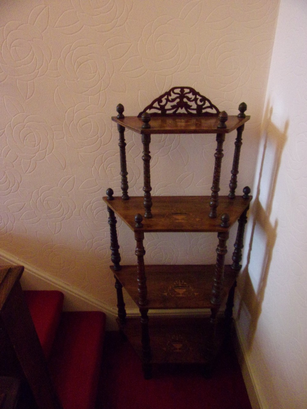A Victorian walnut tiered whatnot stand featuring four tiers with satinwood urn inlay, turned column supports, and a pierced decorative gallery crest. View III