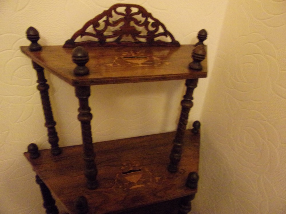 A Victorian walnut tiered whatnot stand featuring four tiers with satinwood urn inlay, turned column supports, and a pierced decorative gallery crest. View IV