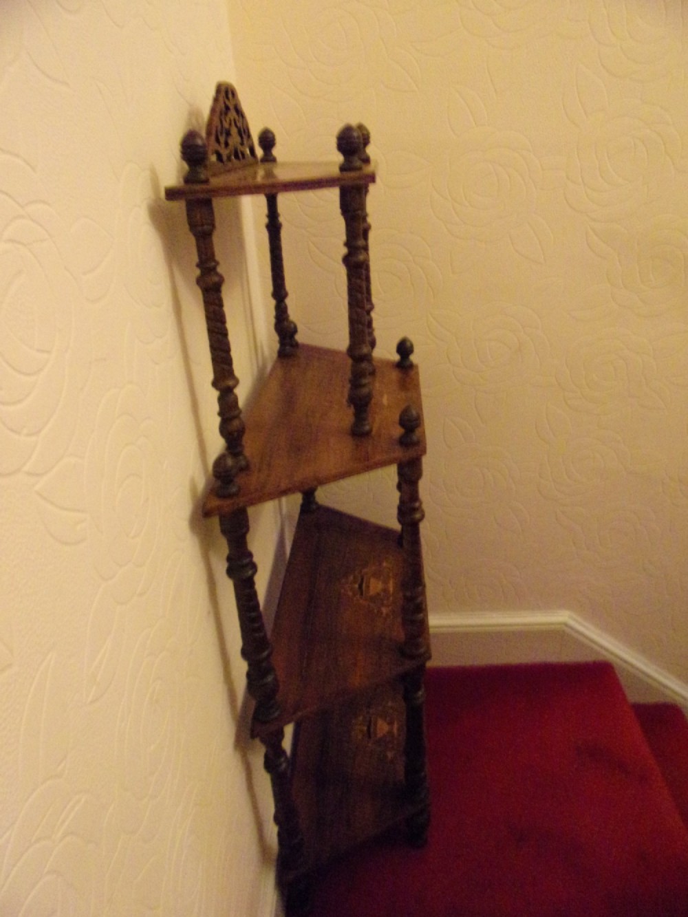 A Victorian walnut tiered whatnot stand featuring four tiers with satinwood urn inlay, turned column supports, and a pierced decorative gallery crest. View V
