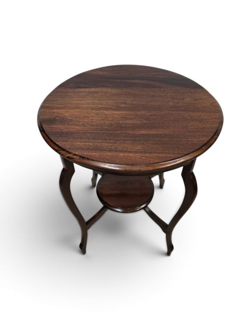 fig 1. A circular dark wood 1930s occasional table featuring curved cabriole legs and a small central lower shelf.