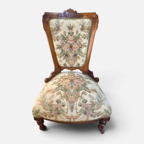 fig 1. A pair of Victorian carved walnut salon chairs upholstered in green floral tapestry fabric, comprising one armchair and one armless slipper chair.