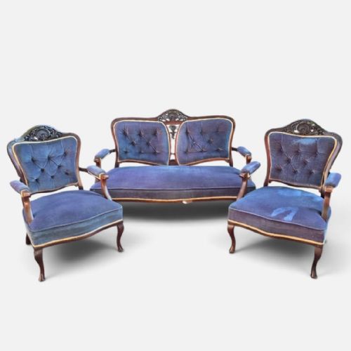 fig 1. A three-piece antique salon suite including a two-seater settee and two matching armchairs upholstered in purple velvet with carved timber frames.