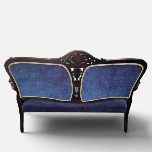 fig 4. A three-piece antique salon suite including a two-seater settee and two matching armchairs upholstered in purple velvet with carved timber frames.