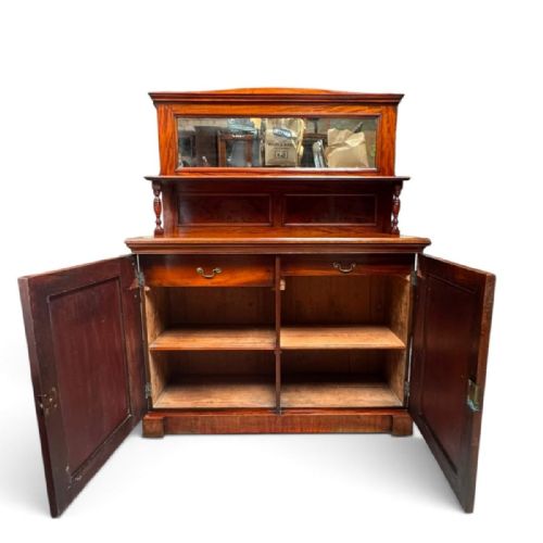 fig 1. A late Victorian mahogany sideboard featuring a raised upper shelf with a rectangular mirror back over a two-door cupboard base flanked by carved corbels.