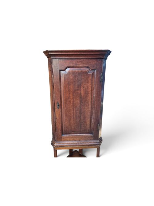 fig 3. A late Victorian English oak corner cupboard featuring a fielded panel door above an open two-tiered stand.