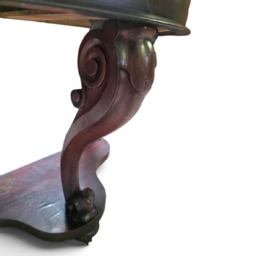 fig 2. A Victorian mahogany washstand featuring a curved white marble top with a splashback and a single carved scroll front leg.