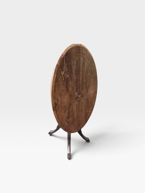 fig 1. An antique Victorian circular walnut centre table featuring central marquetry inlay and a carved pedestal base with four legs.