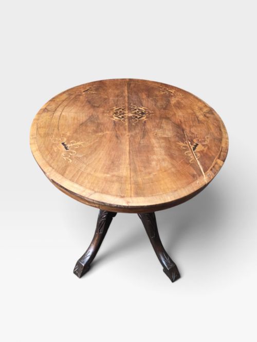fig 2. An antique Victorian circular walnut centre table featuring central marquetry inlay and a carved pedestal base with four legs.