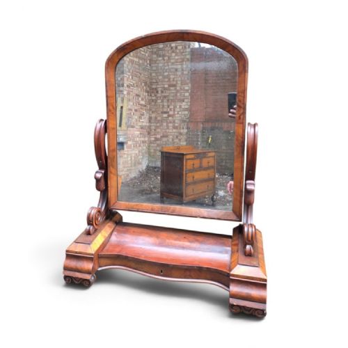 fig 1. A William IV mahogany dressing table mirror featuring an arched frame, carved scroll supports, and a shaped plinth base.