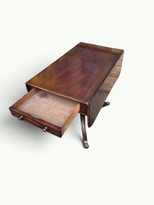 fig 1. A William IV mahogany Pembroke table featuring drop-leaf flaps, a central turned pedestal, and four splayed legs with brass paw feet.