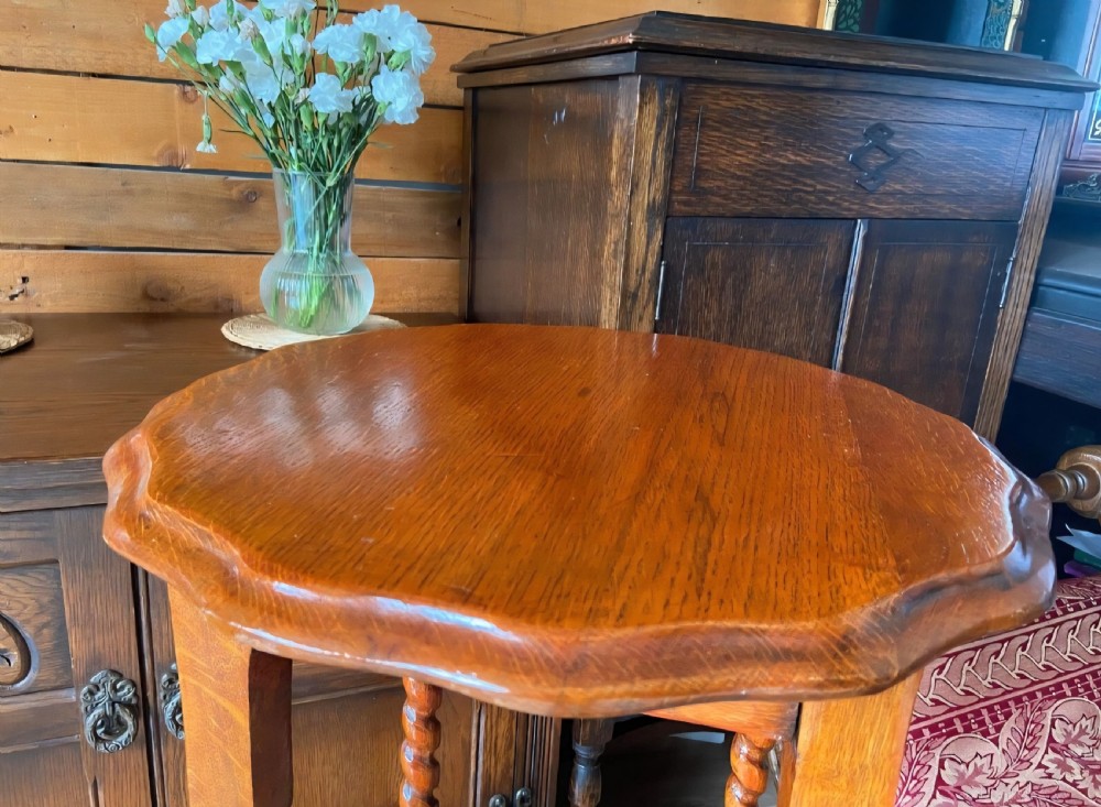A tall medium-brown oak plant stand featuring an octagonal moulded top, four barley twist turned legs, and lower square stretchers. View III