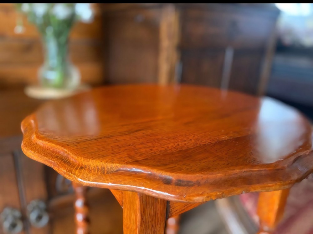 A tall medium-brown oak plant stand featuring an octagonal moulded top, four barley twist turned legs, and lower square stretchers. View VIII
