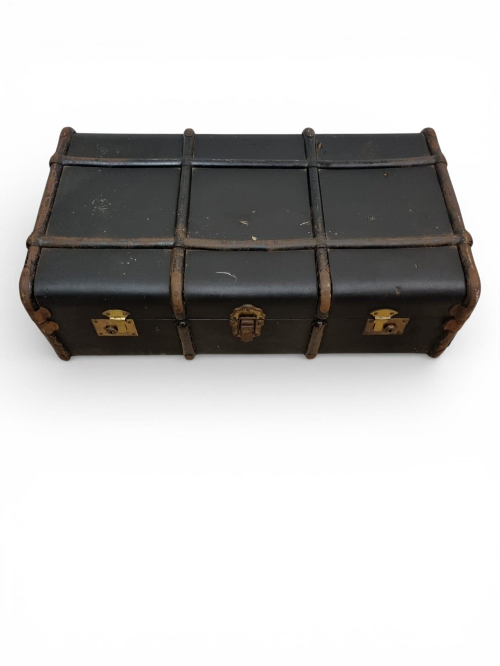 A rectangular black travel trunk featuring dark wooden reinforcement bands, brass latches, and reinforced metal corner caps. View III