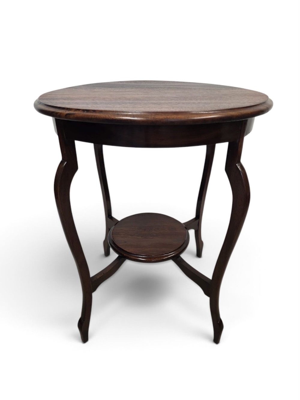 A circular dark wood 1930s occasional table featuring curved cabriole legs and a small central lower shelf.