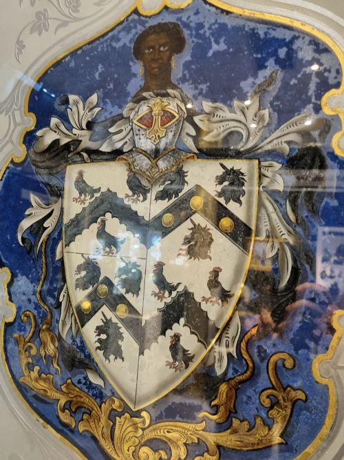 fig 1. A VERRE EGOMISE GLASS FRAMED PANEL.BEARING THE ARMS OF ST THOMAS MORE