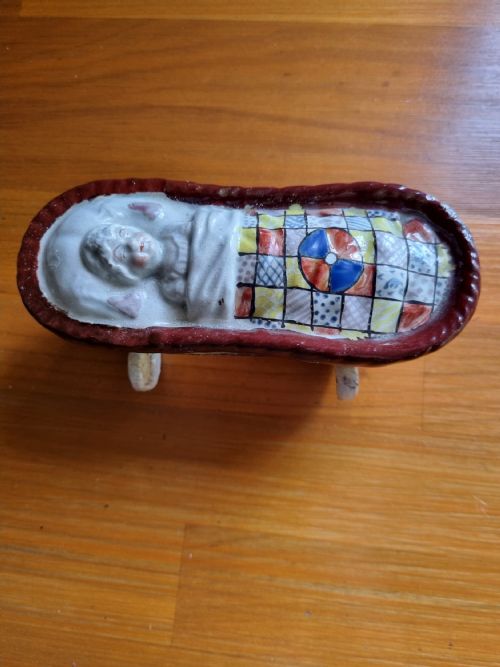 Good Yorkshire Prattware Pottery Baby in a Crib