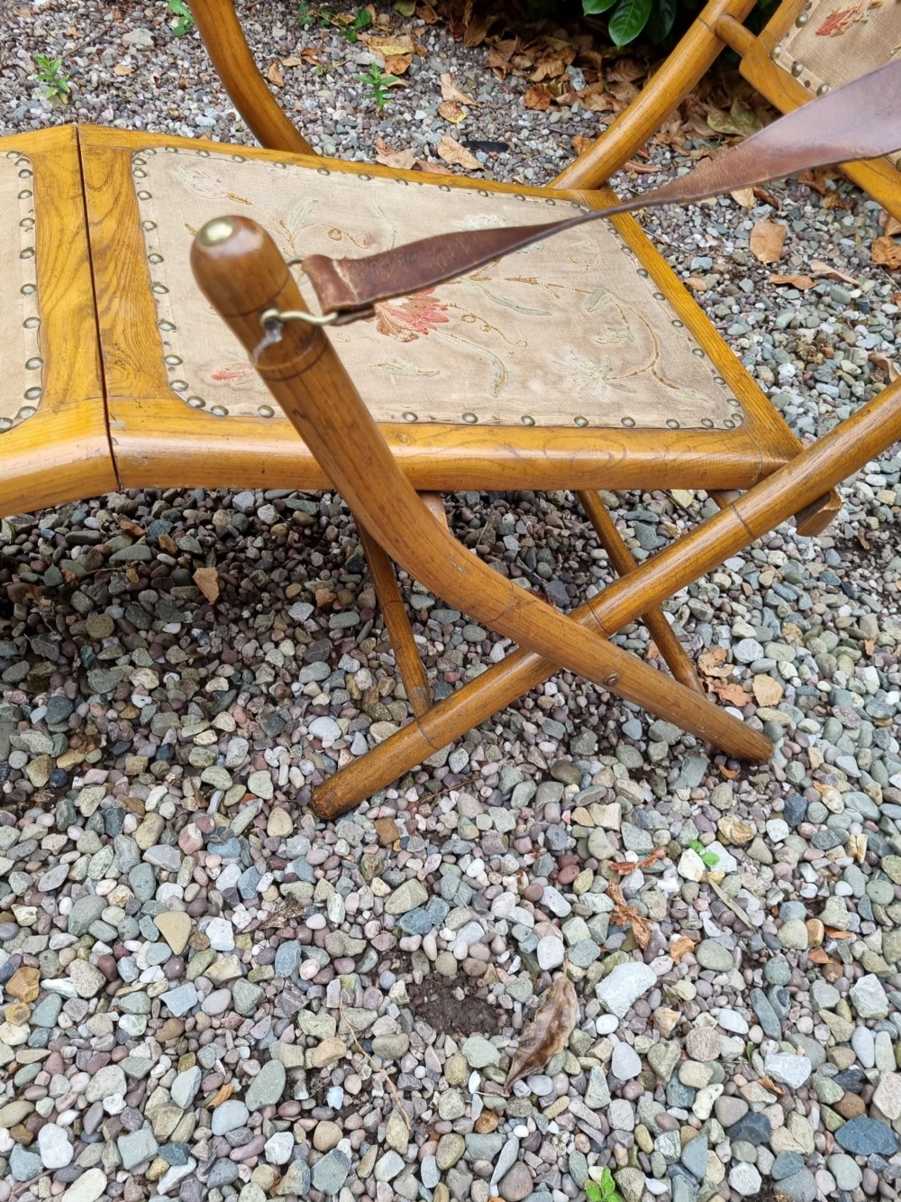 A 19th-century light oak folding lounge chair with floral tapestry panels, leather strap armrests, and an extended footrest. View IV