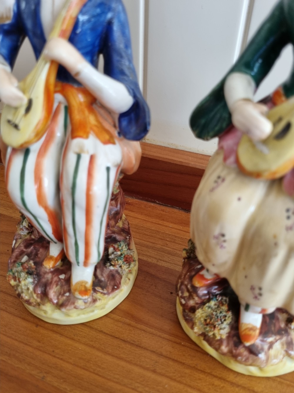 A pair of nineteenth-century Staffordshire earthenware figures depicting a seated male and female musician in colourful orientalist costume playing lutes. View III