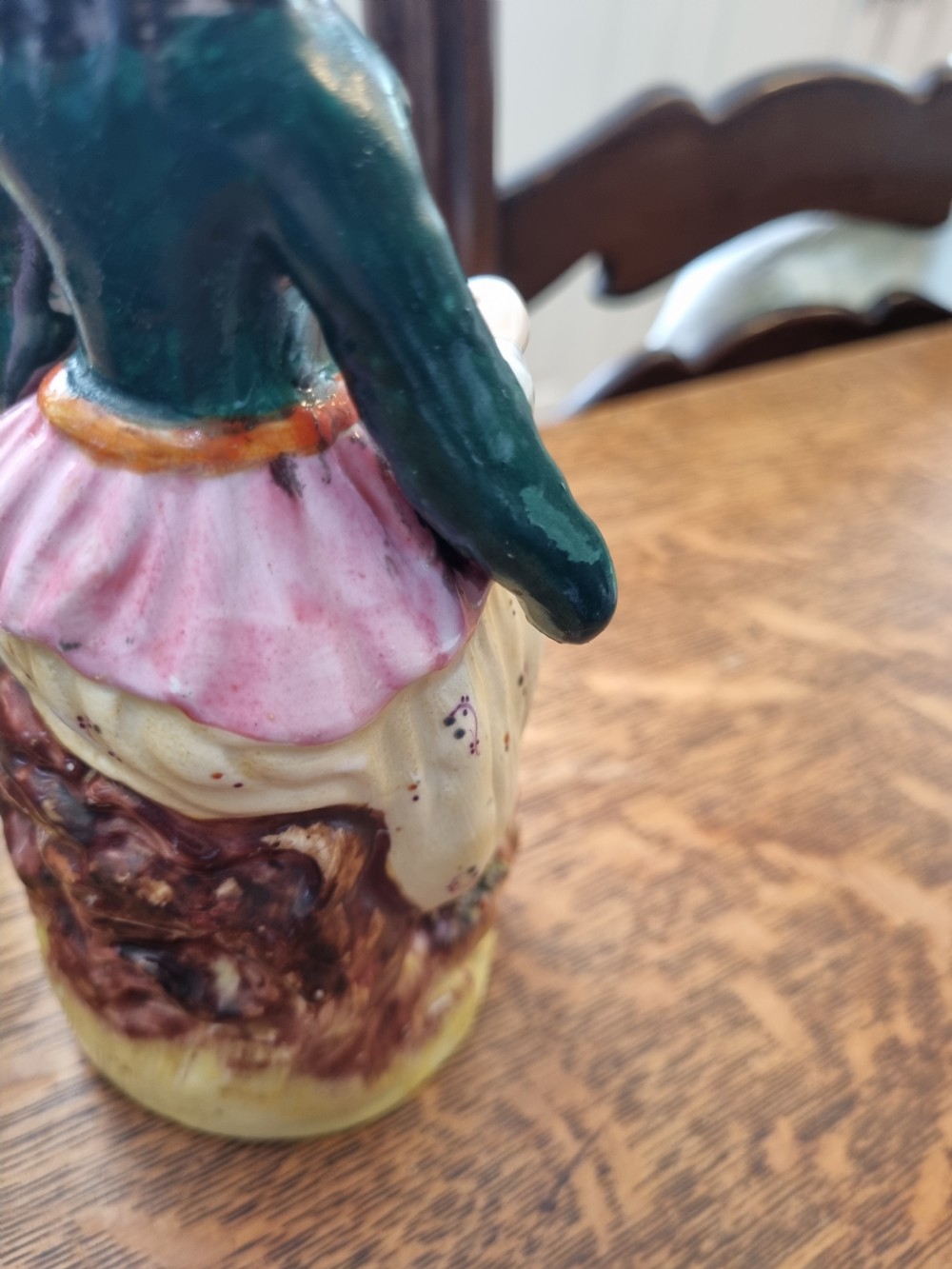 A pair of nineteenth-century Staffordshire earthenware figures depicting a seated male and female musician in colourful orientalist costume playing lutes. View VIII