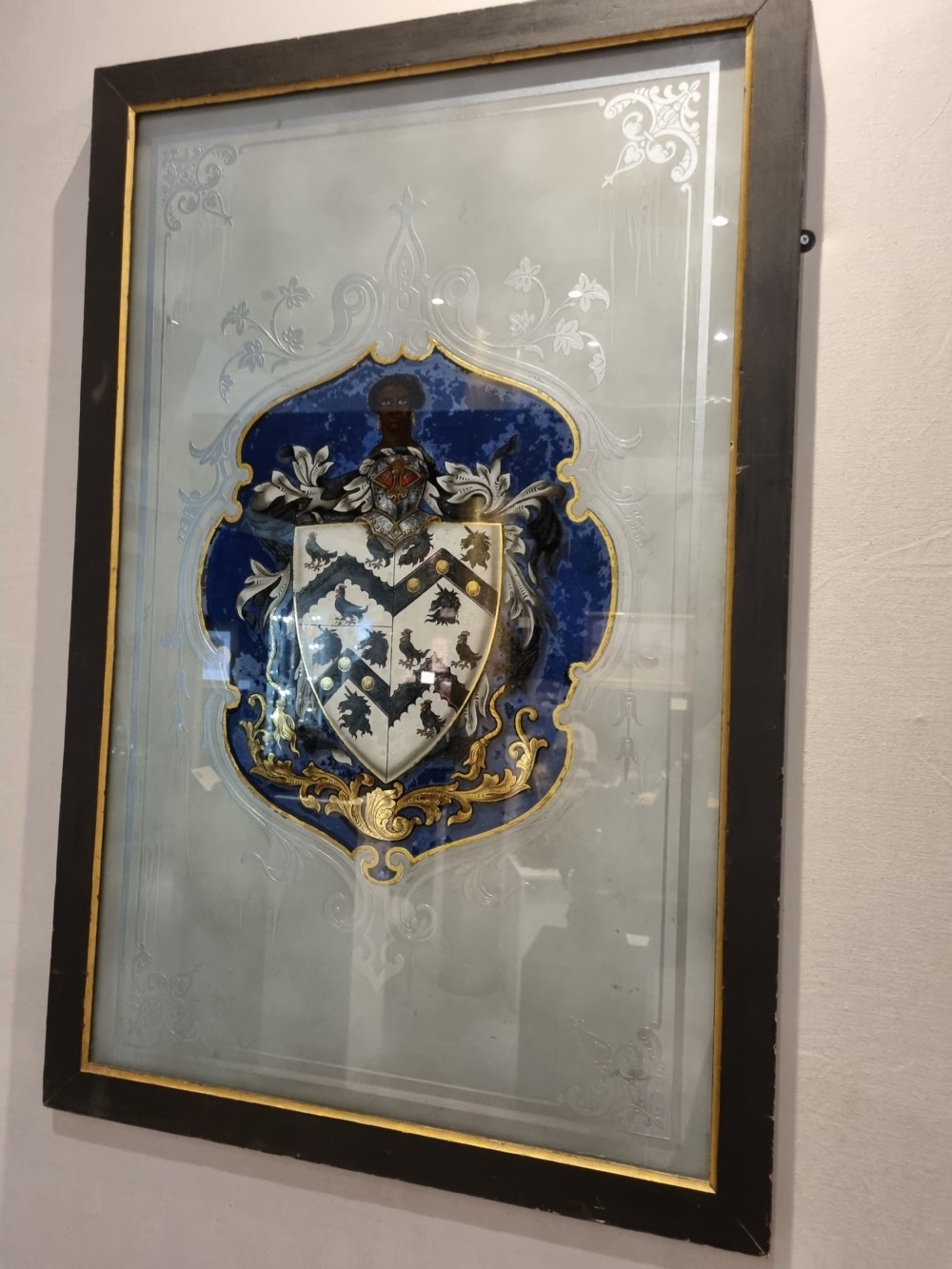 A VERRE EGOMISE GLASS  FRAMED PANEL.BEARING THE ARMS OF ST THOMAS MORE  View III