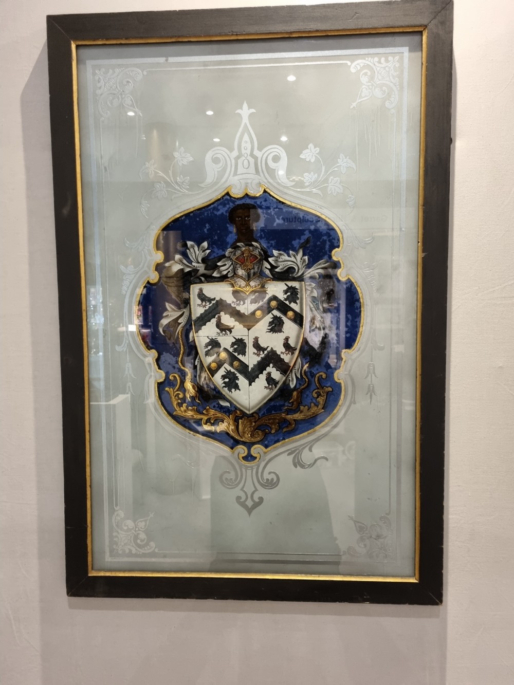 A VERRE EGOMISE GLASS  FRAMED PANEL.BEARING THE ARMS OF ST THOMAS MORE  View IV