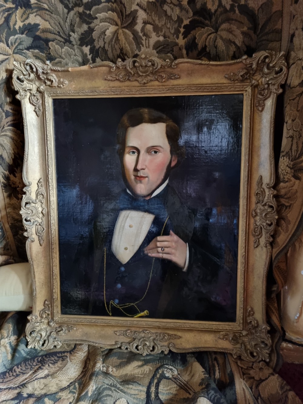 A nineteenth-century oil portrait depicting a young gentleman wearing period attire, set within an ornate gilded frame. View VI