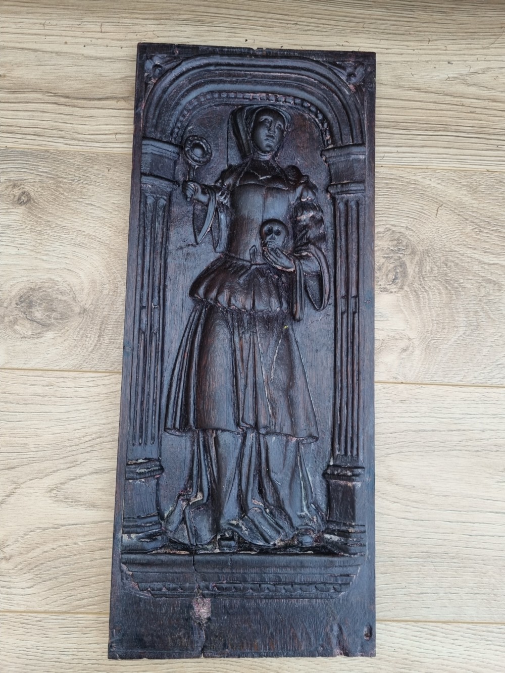 E 17THC OAK CARVED PANEL OF A LADY HOLDING A SKULL AND ORB. View V