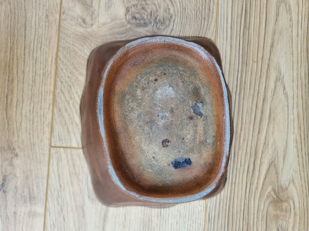 A square brown glazed stoneware jelly mould with a central Prince of Wales feathers relief motif and stepped fluted sides. View III