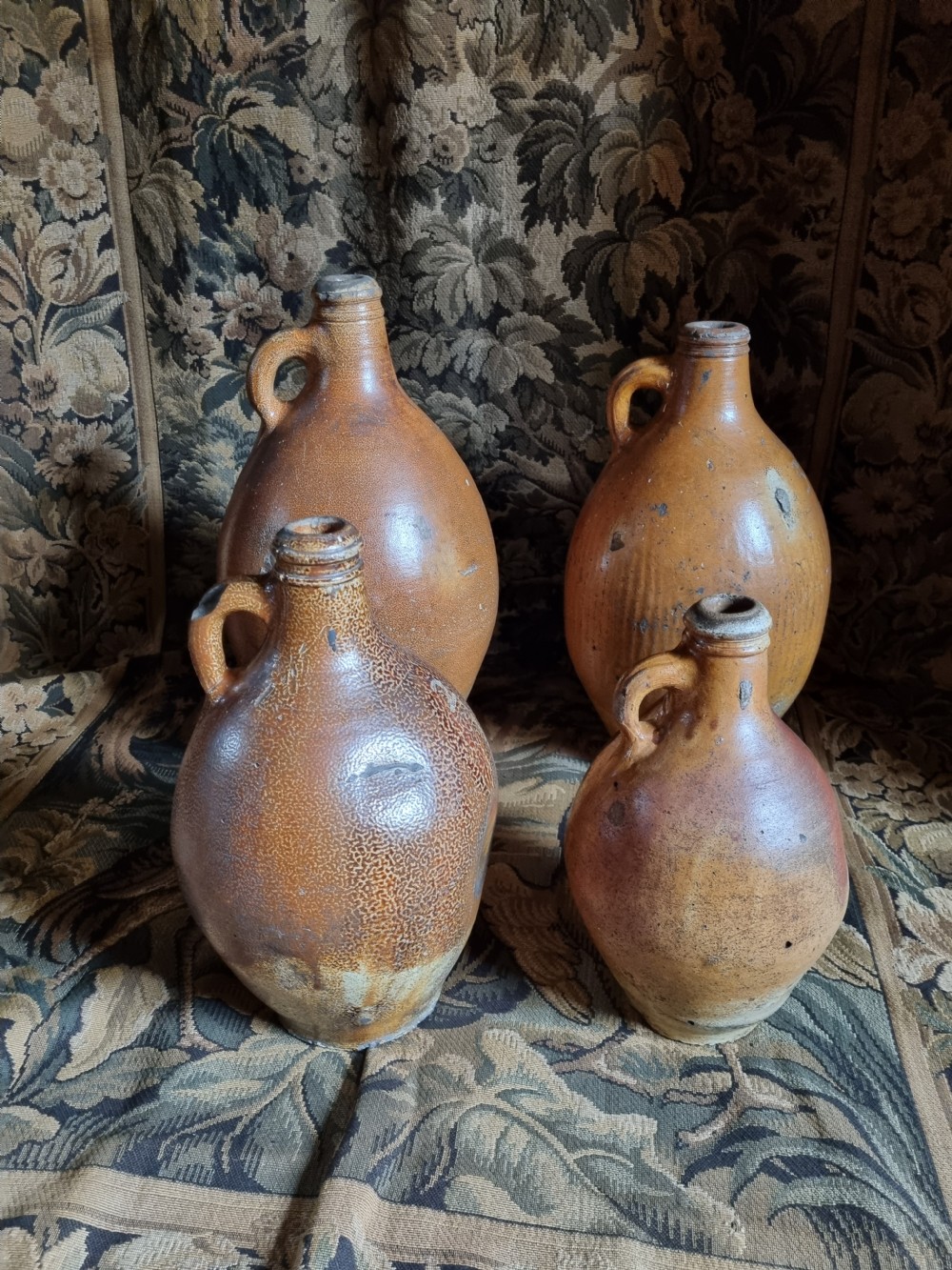 A MATCHED SET OF 4 17TH C STONEWARE  WINE JARS (BELLAMINES) View II