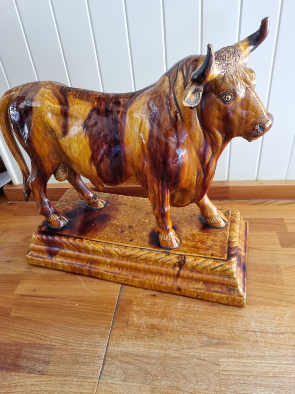 A LARGE POTTERY MODEL OF A BULL USED IN BUTCHERS SHOPS AS ADVERTISING