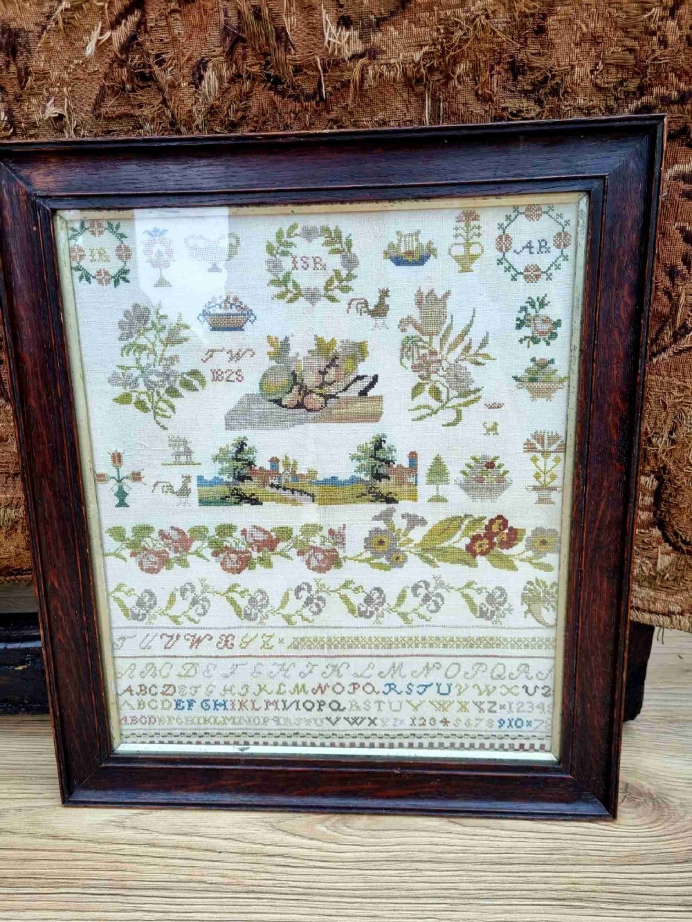 EARLY 19THC NEEDLEWORK SAMPLER IN OAK FRAME DATED 1825 INTIALLED JW