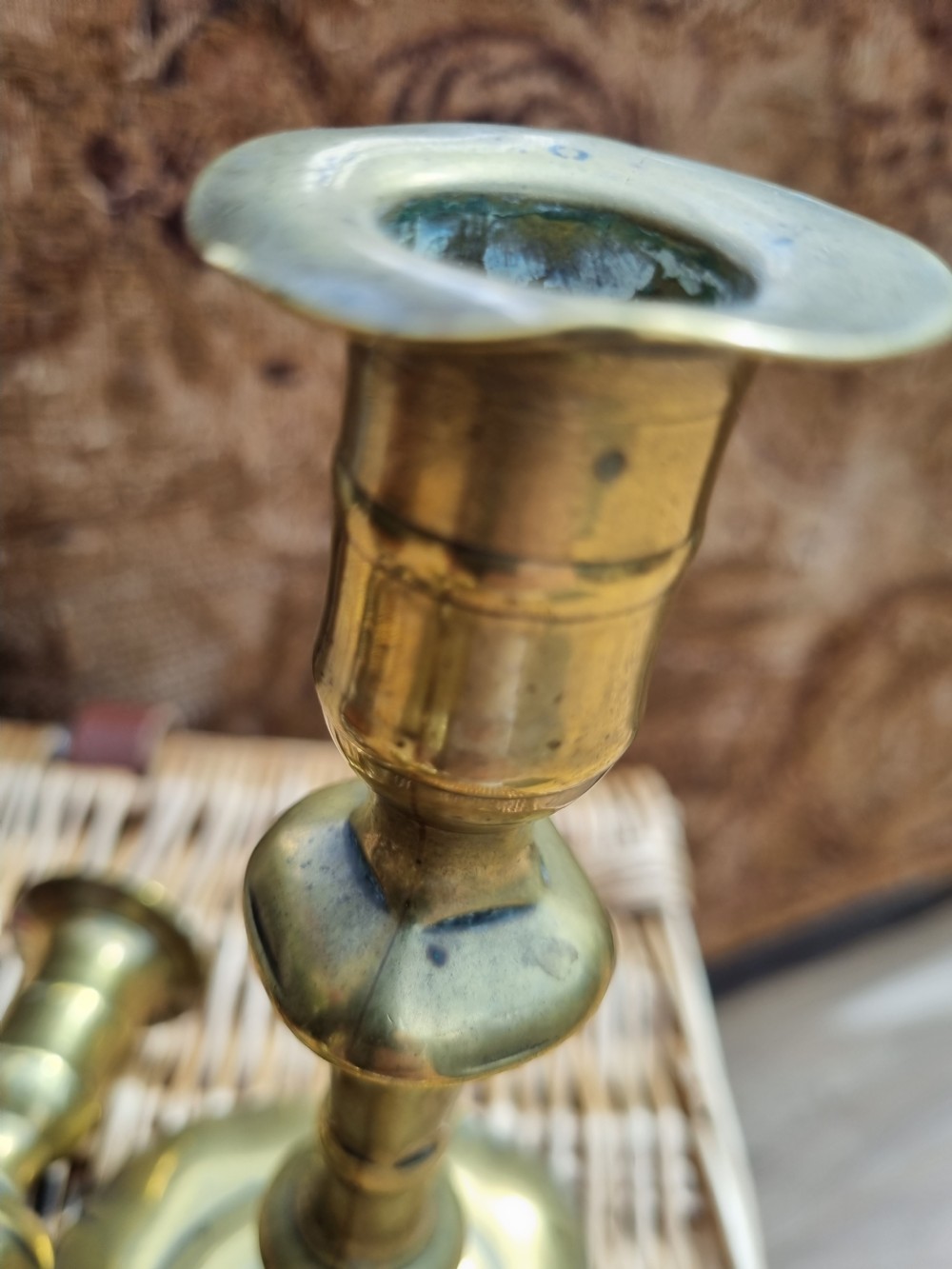 A pair of 18th-century Georgian bell metal candlesticks with turned baluster stems and shaped petal bases. View III