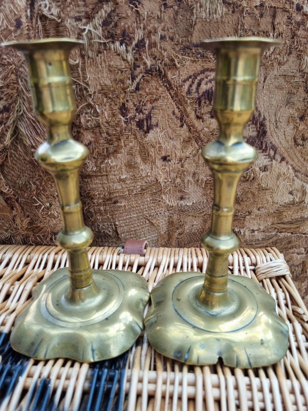 A pair of 18th-century Georgian bell metal candlesticks with turned baluster stems and shaped petal bases. View IV
