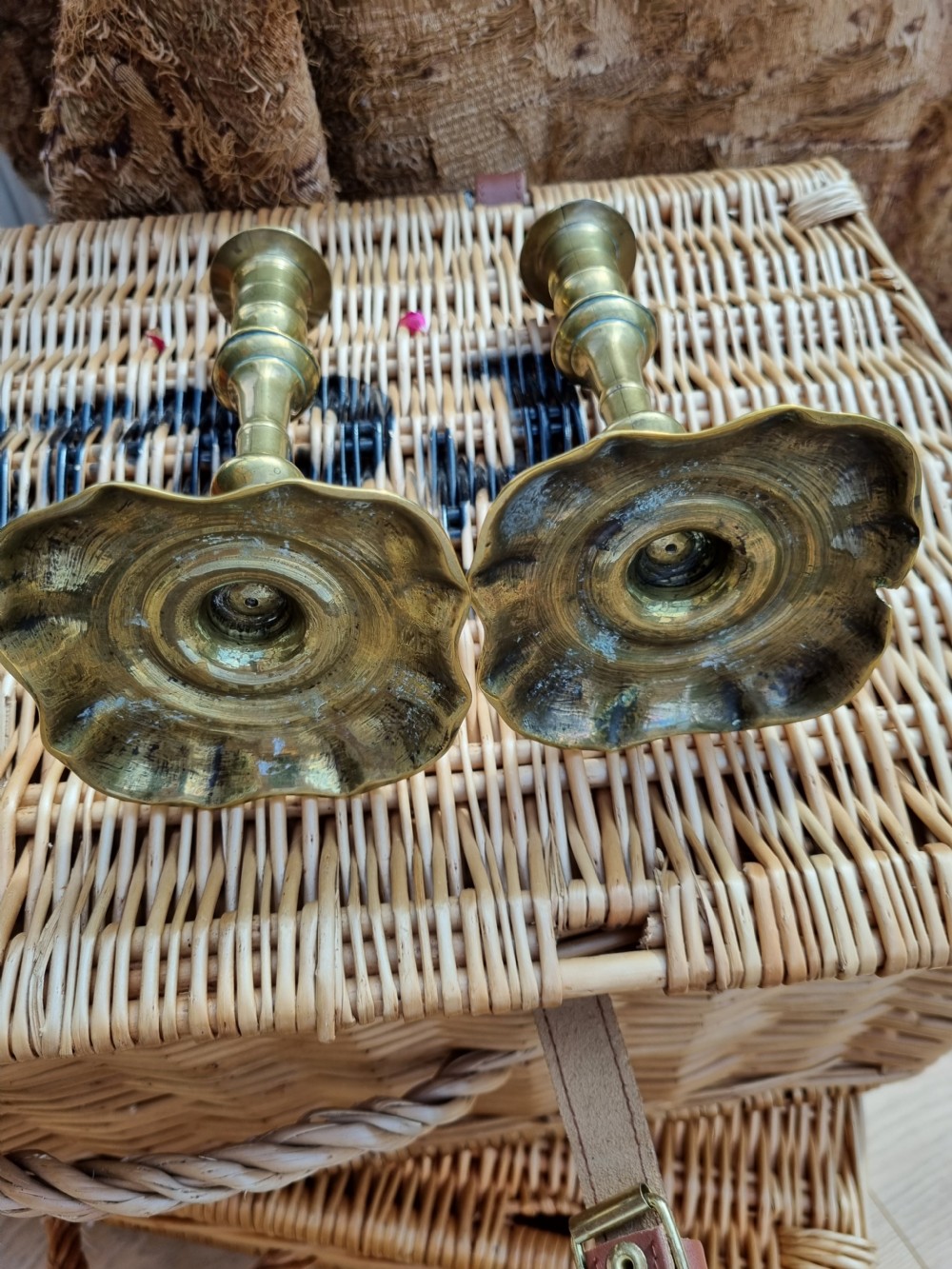 A pair of 18th-century Georgian bell metal candlesticks with turned baluster stems and shaped petal bases. View VII